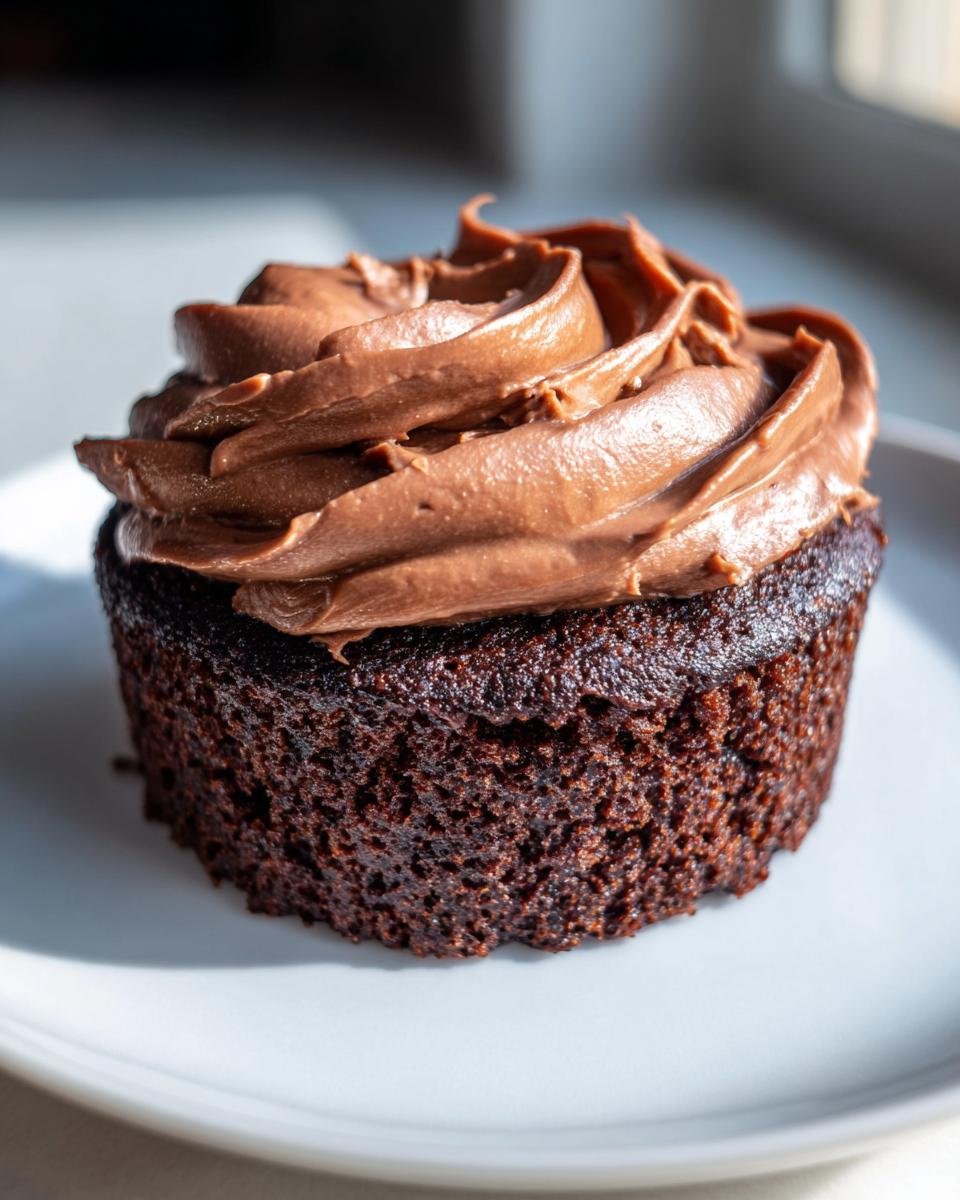 Close-up of a moist chocolate Nutella Cupcakes topped with a swirl of rich chocolate frosting.