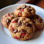 Close-up of delicious Strawberry Chocolate Chip Cookies, studded with dark chocolate chunks and bright red strawberry pieces.