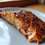 Close-up of a perfectly cooked Air Fryer Mustard Salmon fillet, showing flaky texture and a caramelized glaze.