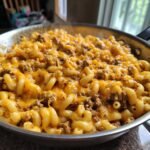 Close-up of steaming Irresistible Cheeseburger Pasta Skillet with elbow macaroni, ground beef, and melted cheddar cheese.