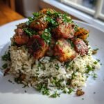A mound of white rice mixed with herbs, topped with crispy roasted potatoes and fresh parsley, part of the Irresistible Roasted Herb Potato Rice Mix Recipe.