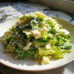 A mound of fresh La Scala Chopped Salad featuring crisp lettuce, chunks of cheese, and grated Parmesan.