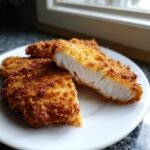 Close-up of Crispy Breaded Chicken Cutlets, showing the golden-brown crunchy exterior and juicy white interior.
