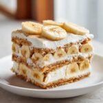Close-up of a layered slice of Irresistible Banana Cream Icebox Cake with bananas and cream.