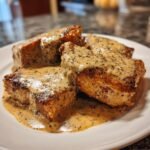 Close-up of seared pork chops generously covered in creamy, speckled Irresistible Peppercorn Sauce Recipe Delight.