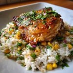 Close-up of a glazed chicken thigh served over Savory One Pan Cilantro Lime Chicken And Rice Recipe.