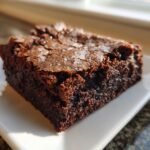 Close-up of a rich, fudgy Paleo Brownies Crackly Top Gluten Free square on a white plate.