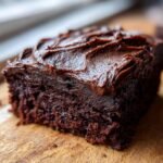 Close-up of a rich, dark chocolate cake slice topped with thick Vegan Chocolate Frosting Paleo Dairy Free.